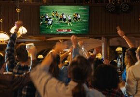 Group,Of,American,Football,Fans,Watching,A,Live,Match,Broadcast